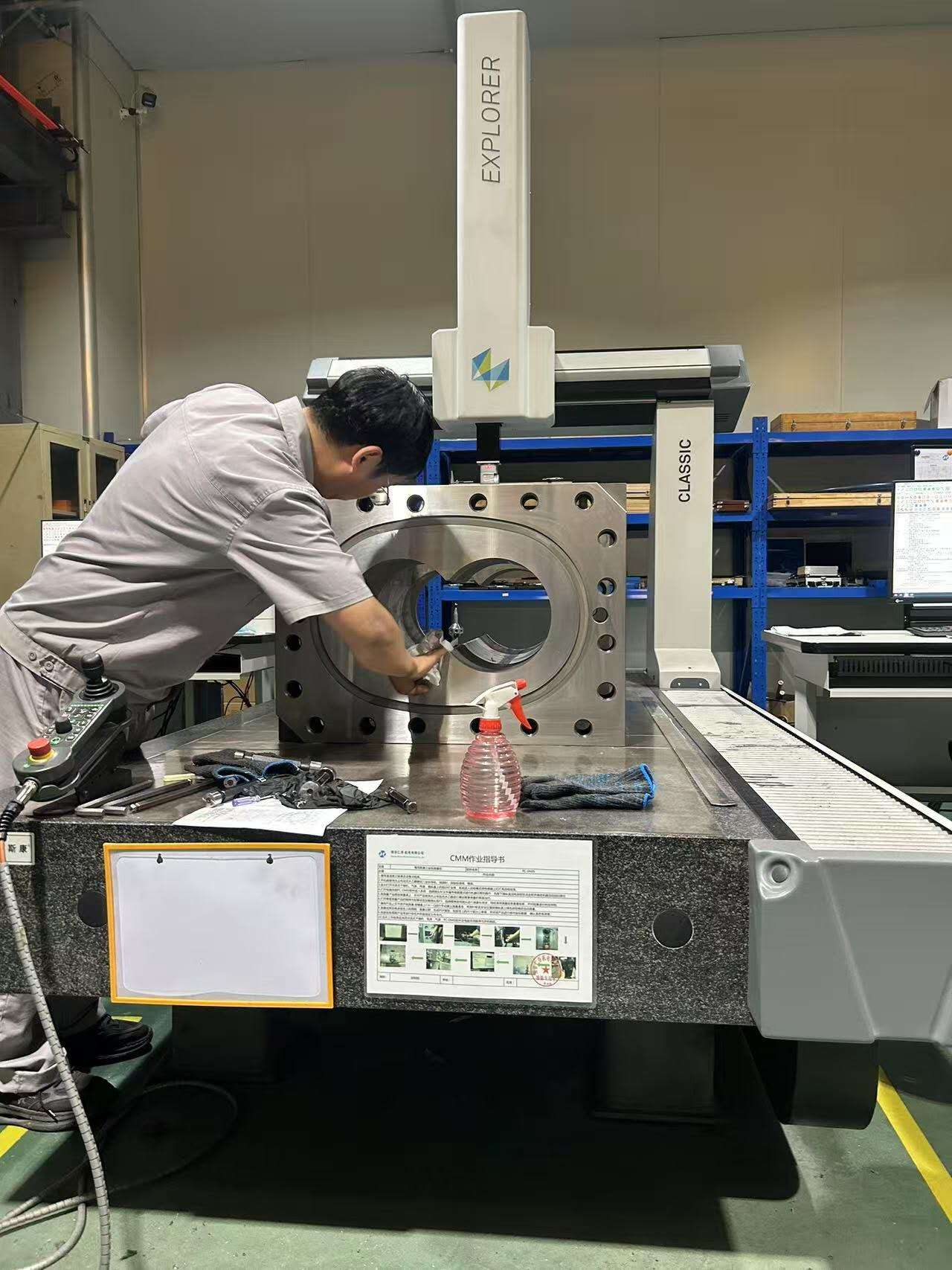 Technician taking metrology readings on a twin-screw barrel