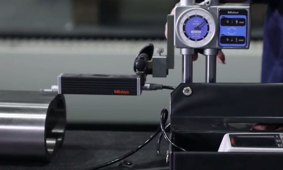 External dial indicator checking runout on a machined surface